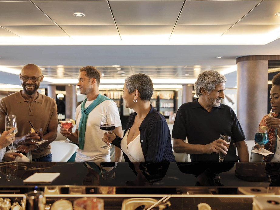 Guests enjoying drinks and conversation together at an Atlas yacht bar